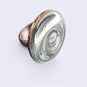 Elegant Silver tone circle sits up to cosmic swirl ring